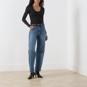 Model wearing Marella black long-sleeve scoop-neck T-shirt, styled with mid-blue straight-leg jeans and black heeled ankle boots.