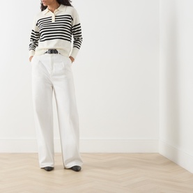 Model wearing Marella cream wool-cashmere striped polo knit top with white wide-leg trousers and black loafers.