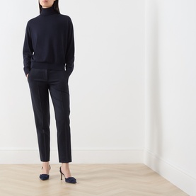 Model wearing Marella navy turtleneck top with tailored navy trousers and navy ballet flats.