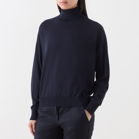 Model wearing Marella navy turtleneck knit top in lyocell, styled with matching navy trousers.