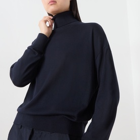 Model wearing Marella navy lyocell turtleneck top with ribbed hem, paired with navy trousers