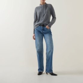 Model wearing Marella Giochi Tie-Neck Sweater in medium grey with tie detail, styled with blue straight-leg jeans and black kitten-heel mules.