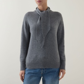 Model wearing Marella Giochi Tie-Neck Sweater in medium grey wool-cashmere with tie neck detail, styled with blue jeans.