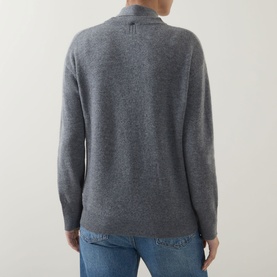 Model wearing Marella Giochi Tie-Neck Sweater in medium grey wool-cashmere, back view showing exposed seams and ribbed trims, styled with blue jeans.