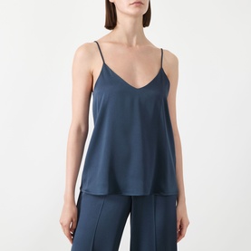 Model wearing Marella aviation blue satin camisole top with V-neck and thin straps, styled with matching wide-leg trousers