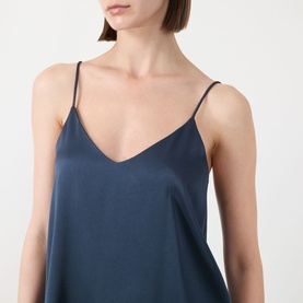 Model wearing Marella aviation blue satin cami top with V-neckline and thin shoulder straps, close-up detail shot.