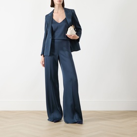 Model wearing Marella aviation blue satin camisole top, styled with matching wide-leg trousers and blazer, holding cream clutch bag.