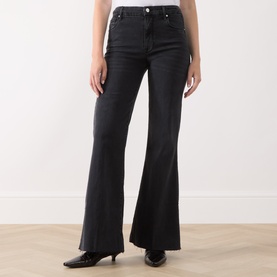 Model wearing Marella black flared jeans in cotton blend, styled with black pointed-toe heeled mules.
