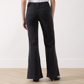 Model wearing Marella black flared jeans, rear view showing high-rise waist, back pockets and wide flared leg hem.
