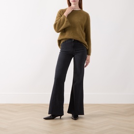 Model wearing Marella black flared trousers in cotton blend, styled with a mustard knit jumper and black pointed heels