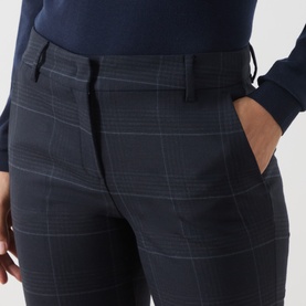 Model wearing Marella navy check trousers, close-up of tailored fit with side pocket and subtle windowpane pattern.