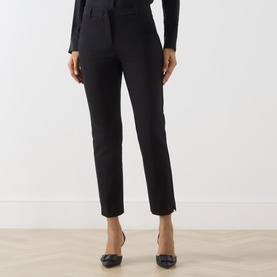Model wearing Marella black slim-leg trousers with a cropped ankle length, styled with a black top and pointed-toe heels.