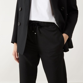 Model wearing Marella black drawstring trousers in wool-polyester blend, styled with a black blazer and white T-shirt