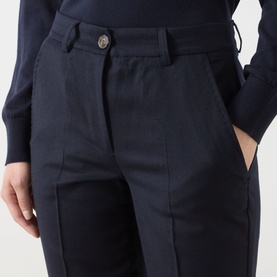 Model wearing Marella Macina Straight Leg Trousers in navy, showing button fastening, belt loops, and side pockets, styled with a navy knit top.