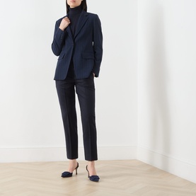 Model wearing Marella Macina Straight Leg Trousers in Navy Plain, styled with a matching navy blazer, black turtleneck and navy heels.