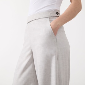 Model wearing Marella Pausa Wide-Leg Trousers in light grey, mid-rise with covered waistband and button detail, hand in pocket, styled with white top.
