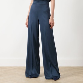 Model wearing Marella Aviation blue wide-leg satin trousers with high waist and front pleats, styled with a matching top.