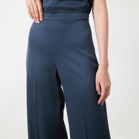 Model wearing Marella aviation blue wide-leg trousers with front seam detail, styled with matching top