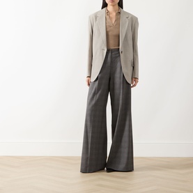 Model wearing Marella Carena Prince of Wales Wide Leg Trousers in grey check, styled with a beige blazer and tan top.