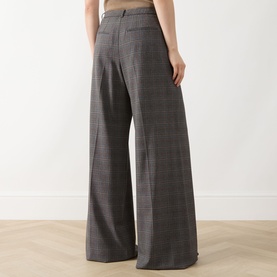 Model wearing Marella Carena Prince of Wales Wide Leg Trousers in grey check, showing rear welt pockets and wide-leg silhouette.