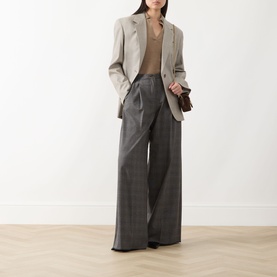 Model wearing Marella Carena Prince of Wales Wide Leg Trousers in grey check, styled with a cream blazer and tan knit top.