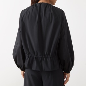 Model wearing Max&Co Moli Technical Blouse in black, back view, showing elasticated waist, long balloon sleeves and round neckline