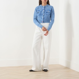 Model wearing Max&Co Staffa Stone-Washed Cardigan in Deep Blue with white wide-leg trousers and black flats.