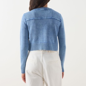 Model wearing Max&Co Staffa Stone-Washed Cardigan in Deep Blue, back view, cropped cotton knit with ribbed hem, styled with white trousers.