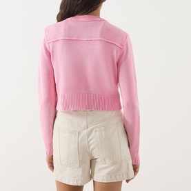 Model wearing Max&Co Staffa Stone-Washed Cardigan in pink, rear view, showing ribbed trim hem, styled with cream shorts.