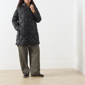 Model wearing Max&Co Vello Quilted Coat in black with onion quilting and hood, styled with khaki wide-leg trousers and black flats.