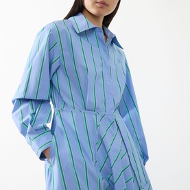 Model wearing Max&Co Ritmo Stripe Shirt Dress in light blue with green stripes, pointed collar, long sleeves and cinched waist