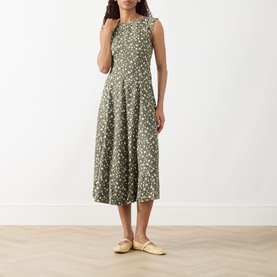 Model wearing Max&Co Virgola Floral Dress in Kaki Print, sleeveless midi length with fitted bodice and flared skirt, styled with cream flat shoes