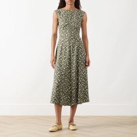 Model wearing Max&Co Virgola Floral Dress in Kaki Print, sleeveless midi with fitted bodice and flared skirt, styled with cream mules