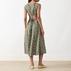 Model wearing Max&Co Virgola Floral Dress in Kaki Print, showing open cut-out back detail, midi length flared skirt, styled with gold flat mules