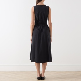 Model wearing Max&Co black sleeveless midi dress with elasticated waist and A-line skirt, shown from the back.