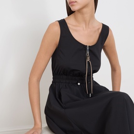 Model wearing Max&Co black sleeveless dress with scoop neck, elasticated waist, and decorative zip-pull detail at centre front.