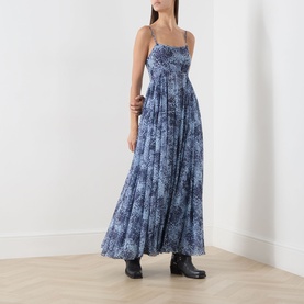 Model wearing Max&Co light blue floral print maxi dress with ruched bodice and thin straps, styled with black ankle boots