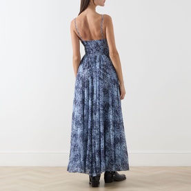 Model wearing Max&Co light blue paisley-print maxi dress with spaghetti straps, smocked bodice and full pleated skirt, back view