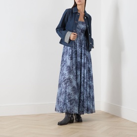 Model wearing Max&Co light blue floral print maxi dress, styled with denim jacket and black ankle boots