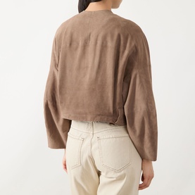 Model wearing Max&Co turtledove goat leather jacket, back view, with wide sleeves and cropped hem, styled with cream jeans