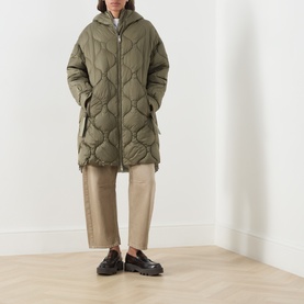 Model wearing Max&Co Vello Quilted Coat in kaki with onion quilting, hood, and two-way zip, styled with wide-leg trousers and loafers