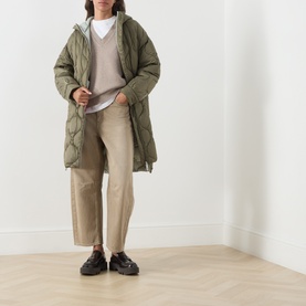 Model wearing Max&Co Vello Quilted Coat in kaki with onion quilting, hood, and long silhouette, styled with beige trousers and black loafers