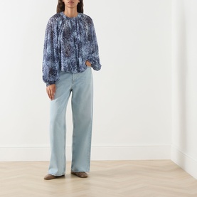 Model wearing Max&Co Ghiglia Printed Blouse in light blue with floral print, balloon sleeves, styled with wide-leg light wash jeans