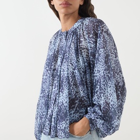 Model wearing Max&Co Ghiglia Printed Blouse in light blue leopard print with balloon sleeves, band collar and pleated detail, styled with light blue