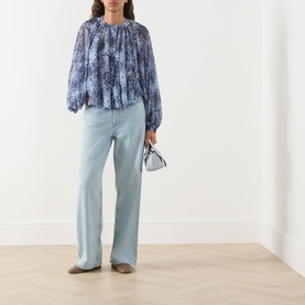 Model wearing Max&Co Ghiglia Printed Blouse in light blue with pleated detail and balloon sleeves, styled with pale blue wide-leg jeans and beige