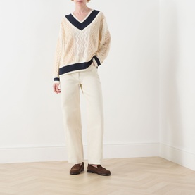 Model wearing Max&Co Pinne Lace Panel Sweater in Milk Bi with navy trim, styled with cream wide-leg trousers and brown loafers