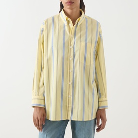 Model wearing Max&Co Dama Stripe Shirt in yellow with blue and white vertical stripes, button-down collar and chest pocket, styled with blue jeans.