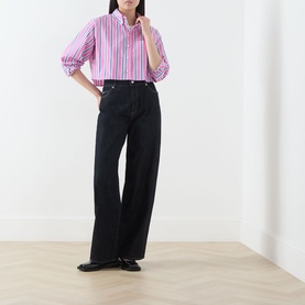 Model wearing Max&Co pink pinstripe cotton shirt with black wide-leg jeans and black loafers