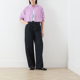 Model wearing Max&Co pink pinstripe cotton shirt, styled with dark wide-leg jeans and black loafers