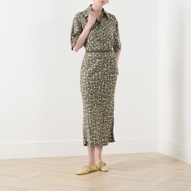 Model wearing Max&Co Agenda Printed Skirt in kaki print floral midi length, styled with matching shirt and yellow flat shoes